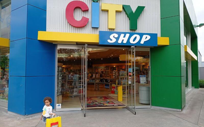 A little girl standing in front of the shop in Legoland Germany