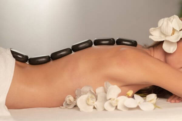 A woman during a hot stone massage