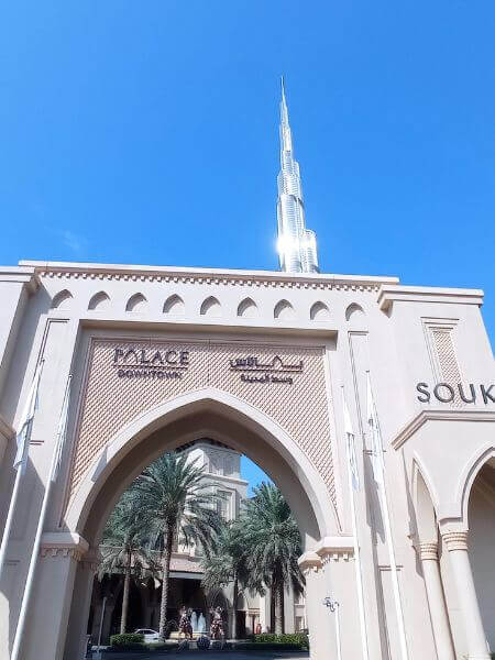 Palace Downtown Hotel, Dubai Entrance to Palace Downtown Hotel in Dubai with the Burj Khalifa rising in the background on a clear blue sky.