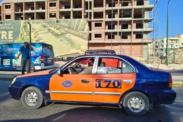 Taxi in Hurghada Egypt A blue and orange city taxi on the street in Hurghada, Egypt.