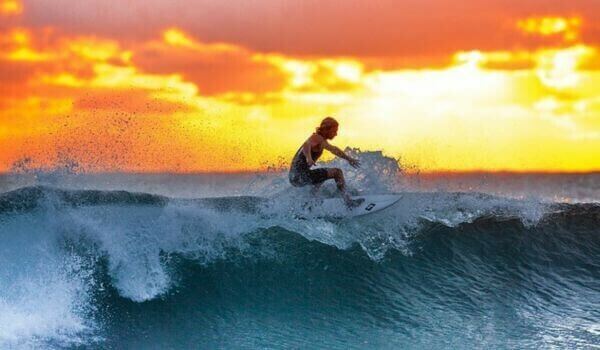 A man surfing during sunset