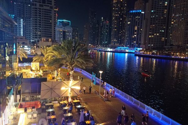 People walking in Dubai Marina at night