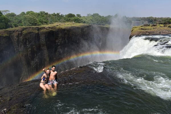 Me and my husband sitting in Devil's Pool, Victoria Falls