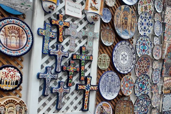 Andalusia, Ceramics Ceramic souvenirs from Andalusia. Colorful plates and crosses decorated with local patterns, on display at a market stall.