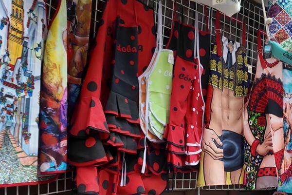 Andalusia, Textile Textile souvenirs hanging in a shop in Andalusia, including red and black polka dot aprons and printed tea towels with flamenco designs from Córdoba.