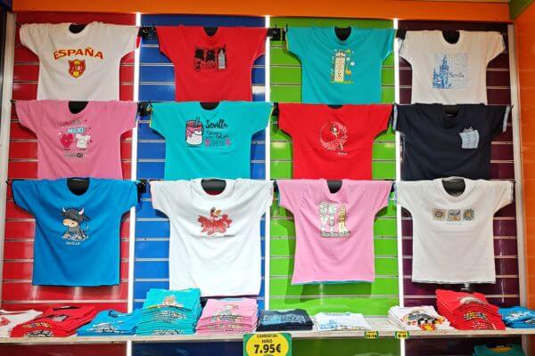 Andalusia, tshirts Colorful souvenir t-shirts on display in a shop in Andalusia, with prints of Spain and Seville.