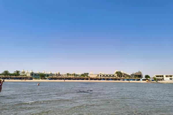 Beach at Titanic Royal The private beach at Titanic Royal Resort in Hurghada, Egypt, with sun loungers and the hotel buildings visible from the water.