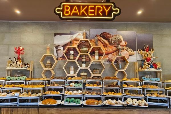 Breakfast in the main restaurant at Titanic Royal The bakery section of the breakfast buffet at Titanic Royal Resort in Hurghada, Egypt, with a large selection of bread, pastries and donuts.