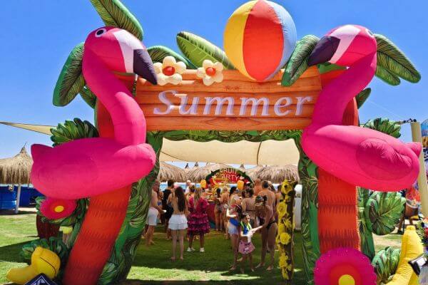 Fruit Party at Titanic Royal A fruit party on the beach at Titanic Royal Resort in Hurghada, Egypt, with a colorful summer arch decoration and guests gathered underneath.