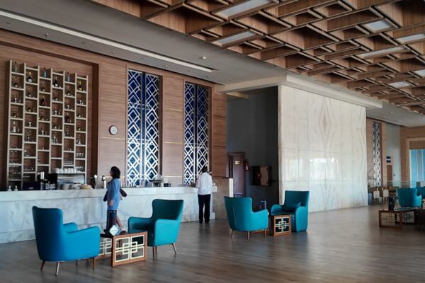 Lobby Bar at Titanic Royal The lobby bar at Titanic Royal Resort in Hurghada, Egypt, with blue armchairs, a marble bar counter and wooden ceiling.