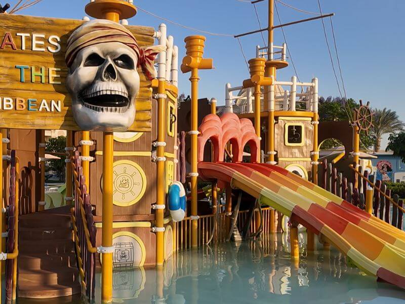 A Pirates of the Caribbean themed kids pool with small water slides at a beach resort in Hurghada, Egypt.